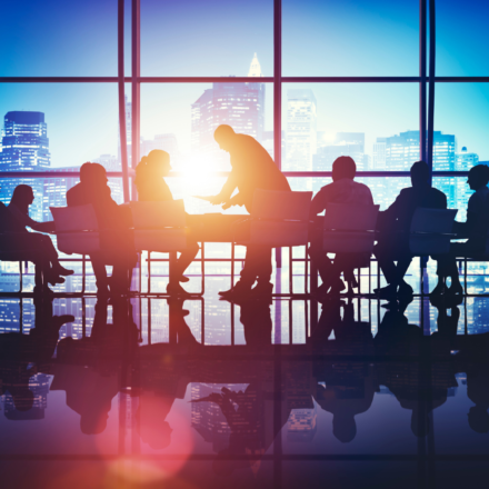 Group of people in silhouette at a business meeting